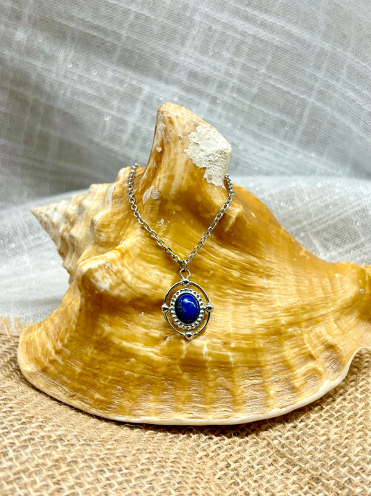 Collier LOUISA, avec pierre de Lapis-Lazuli, exposé sur un coquillage.