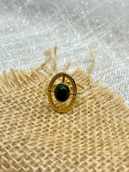 Bague LOUISE, avec pierre de Malachite, exposée sur un fond en toile de jute.