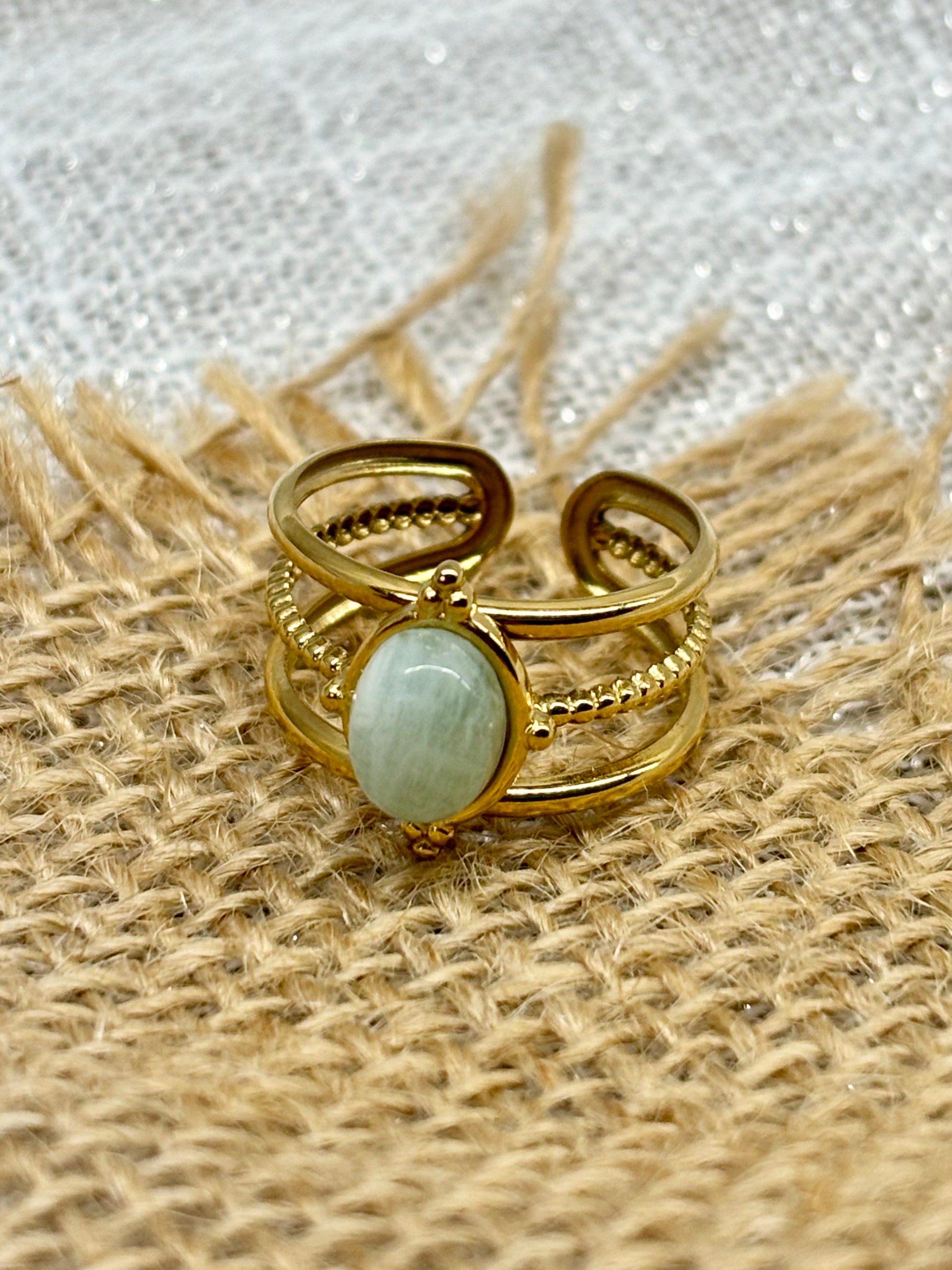 Bague LOUISON, avec pierre d'Amazonite, exposée sur un fond en toile de jute.