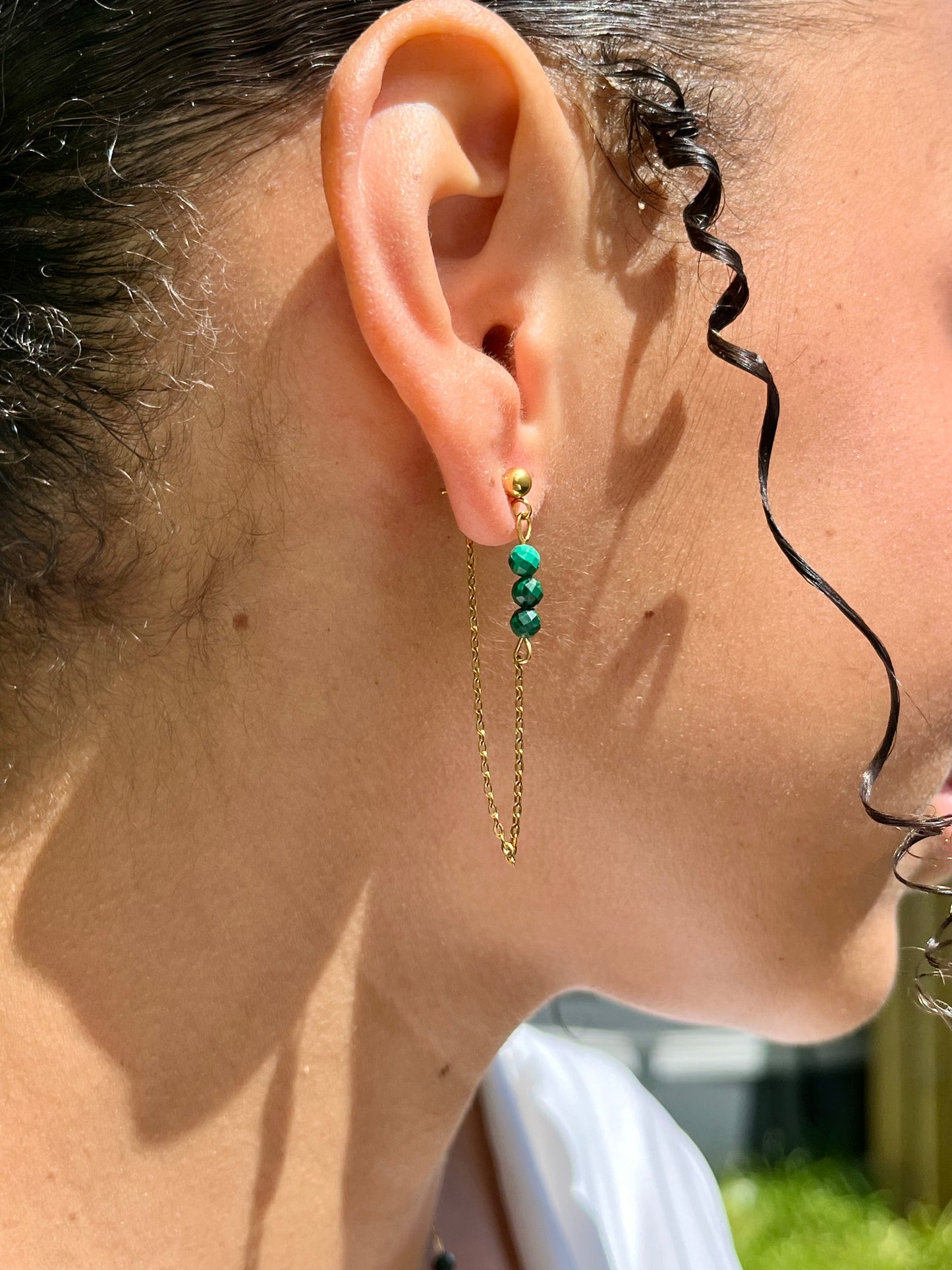 Boucles d'Oreille MALIA, de couleur dorée avec pierres de Malachite, portées.